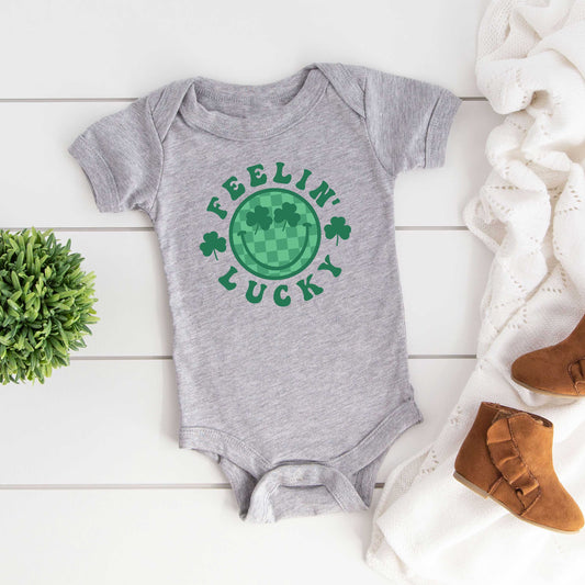 Feelin' Lucky Checkered Smiley Face | Baby Graphic Short Sleeve Onesie